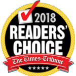 A circular badge with a red checkmark and “2018 Readers’ Choice” in bold letters, featuring “The Times-Tribune” on a red ribbon across the bottom with five stars beneath.