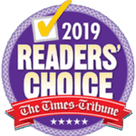 A circular purple badge with 2019 Readers’ Choice in bold white letters, a yellow check mark at the top, and The Times-Tribune in red ribbon across the bottom.
